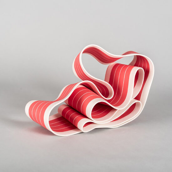 Folding in motion 3: ribbon-like ceramic sculpture by Simcha Even-Chen made with paper porcelain painted in red with white stripes.